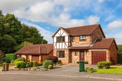 Detached British house with a front garden and driveway